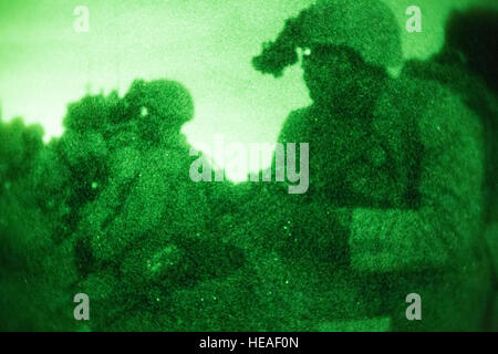 Marines wait to move into an enemy compound during a night raid training evolution aboard Marine Corps Base Camp Pendleton, Calif., April 28, 2016. A raid is one of a Marine Expeditionary Unit’s 13 mission essential tasks, which a Battalion Landing Team will constantly refine prior to their designated deployment. The Marines are with the Light Armored Reconnaissance company of BLT, 1st Bn., 4th Marines, 11th MEU. Stock Photo