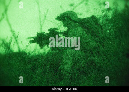 A Marine scouts a simulated enemy compound for hostile activity during a night raid training evolution aboard Marine Corps Base Camp Pendleton, Calif., April 28, 2016. The Marines are refining their mission essential tasks in preparation for their upcoming Western Pacific 16-2 deployment.  The Marines are with the Light Armored Reconnaissance company of Battalion Landing Team, 1st Bn., 4th Marines, 11th Marine Expeditionary Unit. Stock Photo