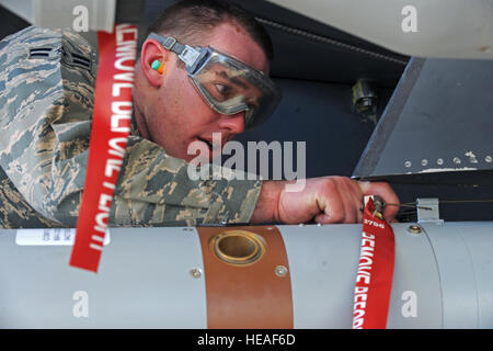 Airman 1st Class Hunter Leger, 4th Aircraft Maintenance Squadron load crew member, wires the Battery Firing Device (BFD) on a Guided Bomb Unit (GBU-12) laser guided bomb during a load crew of the quarter competition at Seymour Johnson Air Force Base, N.C., Jan. 24, 2013. The BFD initiates the process that allows the bomb to hit its designated target.  Airman 1st Class Aaron J. Jenne) Stock Photo