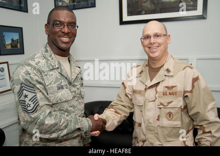 CAMP LEMONNIER, Djibouti (March 16, 2012) - U.S. Navy Air Force Chief Master Sergeant James E. Davis, Combined Joint Task Force Horn of Africa command senior enlisted leader, greets U.S. Navy Reserve Master Chief (AW) Chris T. Wheeler, March 16, during the first stop in an overseas tour with Assistant Secretary of the Navy (Manpower and Reserve Affairs), the honorable Juan M. Garcia and commander, Navy Reserve, Vice Admiral Dirk J. Debbink. The leaders are visiting Sailors and Marines deployed to the Horn of Africa to highlight the wide range of personnel programs covered in the 21st Century S Stock Photo