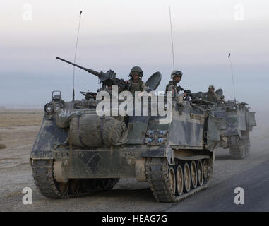 041001-F-2034C-017 U.S. Army armored vehicles leave Samarra after conducting an assault during Operation Baton Rouge in Samarra, Iraq, on Oct. 1, 2004.  Soldiers of the 1st Battalion, 4th Cavalry Regiment, 1st Infantry Division conducted the assault and then surrounded Samarra sealing it off to keep anti-coalition forces from entering or leaving the town.   Staff Sgt. Shane A. Cuomo, U.S. Air Force.  (Released) Stock Photo