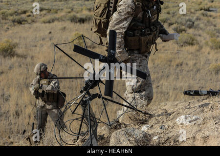 U.S. Marines from the 1st Air Naval Gunfire Liaison Company Supporting Arms Liaison Team establish communications prior to an assault on a Juniper Butte Bombing Range mock village near Mountain Home Air Force Base, Idaho, Oct. 9, 2013, during exercise Mountain Roundup. For SALT officers or NCOs leading strikes, command and control is essential, as is communication.  Master Sgt. Kevin Wallace/) Stock Photo