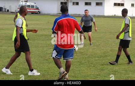 Michigan National Guard 1st Lt. Jeremiah Aberlich, Operation Onward Liberty communications adviser, competes in a mentor-mentee soccer match with Armed Forces of Liberia soldiers at Barclay Training Center, Oct. 31, 2013. The Michigan Nation Guard entered a partnership with Liberia in 2009 as part of the National Guard's State Partnership Program. Aberlich, a Warren, Mich., resident, is among 14 Guardsmen deployed with OOL.  Master Sgt. Brian Bahret) Stock Photo