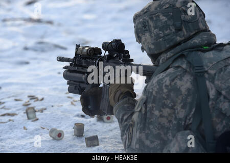 Paratroopers assigned to the 3rd Battalion, 509th Parachute Infantry Regiment, 4th Infantry Brigade Combat Team (Airborne) 25th Infantry Division, U.S. Army Alaska, traverse the snow covered terrain during a live-fire and movement-to-contact operations on the Infantry Squad Battle Course at Joint Base Elmendorf-Richardson, Alaska, Tuesday, Nov. 8, 2016. The soldiers focused on core infantry skills such as fire team movement, communication, shifting fire, and once on the objective identifying and eliminating weapons caches and treating and evacuating casualties.  Airman 1st Class Javier Alvarez Stock Photo