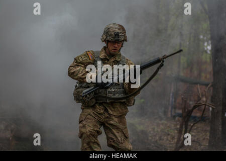 Sgt. 1st Class Dennis Henning, Co. B, 2nd Bn. 13th Inf. Reg., uses a three second rush to bound to his next firing point while taking direct fire during Expert Infantry Badge testing held at Ft. Jackson, S.C., March 31, 2016. Soldiers vying for the coveted Infantry qualification were given 30 timed Army Warrior tasks to complete in addition to being tested on the Army Physical Fitness test, day and night land navigation. Testing ends on April 1 with a 12-mile forced march.  Sgt. 1st Class Brian Hamilton/released) Stock Photo