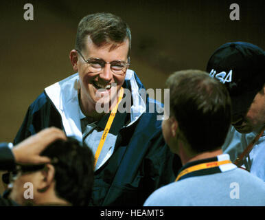 000916-F-8217W-005 Army Staff Sgt. Ken Johnson, of the U.S. Olympic shooting team, smiles after his wife Nancy won the first gold medal for the women's 10 meter air rifle competition at the 2000 Olympic Games in Sydney, Australia, on Sept. 16, 2000.  Nancy JohnsonÕs gold medal is the first awarded in the Sydney Games and the first gold for the U.S.  Husband Ken will compete in the menÕs 10 meter air rifle competition later in the games.  Fifteen U.S. military athletes are competing in the 2000 Olympic games as members of the U.S. Olympic team.   Tech. Sgt. Robert A. Whitehead, U.S. Air Force.  Stock Photo