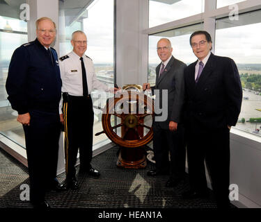 (From Left to right) Gen. Craig R. McKinley, the chief of the National Guard Bureau, Maj. Gen. Raymond F. Rees, Oregon adjutant general, Steve Schreiber, director of Aviation, Portland of Portland and Paul Rosenbaum, Port of Portland commissioner, pose for a photograph during a tour of the Port of Portland offices, given by the Port leaders to McKinley, Sept. 16, 2011. McKinley visit to the port was to show appreciation for 60 years of partnership between the Port of Portland and the Air National Guard. Stock Photo