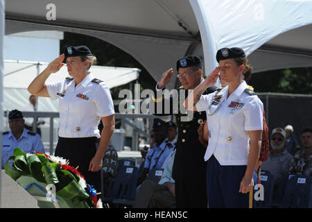 HONOLULU, Hawaii - U.S. Army Maj. Gen. Stephen D. Tom (center), the Commander of the Joint POW/MIA Accounting Command (JPAC) leads an Army contingent in saluting after placing a wreath in honor of those fallen and missing in action during the POW/MIA Recognition Day Ceremony held at the National Memorial Cemetery of the Pacific (Punchbowl) in Honolulu, Hawaii on Sept. 16.  More than 200 past and present military members and civilians gathered with the Joint POW/MIA Accounting Command (JPAC) as they honored those held in captivity or are missing in action from past conflicts.  The third Friday  Stock Photo