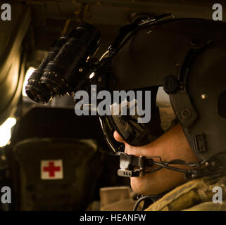 An aerial gunner with the 303rd Expeditionary Rescue Squadron looks out onto the range prior to conducting live fire weapons training working with Joint Tactical Air Controllers from Detachment 1, 82nd Expeditionary Rescue Squadron at the Arta range, Djibouti, June 22, 2015. The 303rd ERQS conducts training events working with enabling units to maintain proficiency while deployed in support of humanitarian aid and contingency operations in the Combined Joint Task Force Horn of Africa area of responsibility. ( Staff Sgt. Gregory Brook Stock Photo