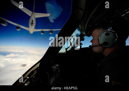 U.S. Air Force Capt. John Wicker prepares to connect to a KC-10 Stratotanker aircraft during a sortie mission over South Carolina April 27, 2010. Aircrew members from Joint Base Charleston conduct aerial training missions periodically to practice air delivery, refueling and low-level tactical maneuvers. Wicker is a pilot with the 17th Airlift Squadron.  Staff Sgt. Angelita Lawrence, U.S. Air Force Stock Photo