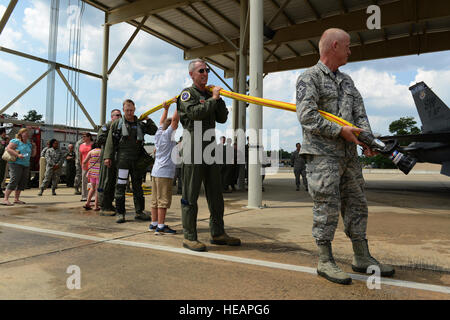 U.S. Air Force Airmen and family members gather for the ceremonial water spraying after U.S. Air Force Maj. Gen. H. D. Polumbo Jr., Ninth Air Force commander, had his final flight at Shaw Air Force Base, S.C., June 26, 2015. Airmen, community leaders, family and friends greeted Polumbo after his fini-flight to thank him for his service and congratulate him on his retirement.  Senior Airman Diana M. Cossaboom Stock Photo