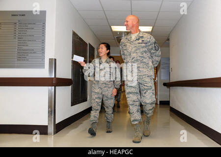 U.S. Air Force Chief Master Sgt. Scott Fuller, Ninth Air Force command chief, is led on a tour of the 4th Medical Group by Airman 1st Class A Xiong, 4th Aerospace Medicine Squadron public health technician, during a visit to Seymour Johnson Air Force Base, N.C., Nov. 21, 2013. Fuller toured several units during his visit, including the Airman Leadership School and 4th Aircraft Maintenance Squadron in addition to the medical group.  Airman 1st Class John Nieves Camacho) Stock Photo