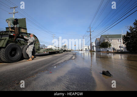 Soldiers from the 150th and 160th Engineer Companies, New Jersey Army National Guard, prepare to move D7 bulldozers to perform beach replenishment operations, Nov. 8, 2012, in the devastated Holgate section of Long Beach Island, N.J., following Hurricane Sandy and Nor'easter Athena.  More than 2,000 soldiers and airmen from the New Jersey National Guard have been mobilized in response to Hurricane Sandy.   Master Sgt. Mark C. Olsen Stock Photo