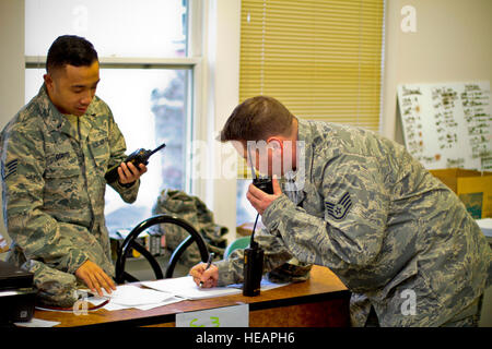 New Jersey Air National Guardsmen from the 108th Wing and 177th Fighter Wing conduct radio checks at the Manahawkin Armory, Stafford Township, N.J. Airmen and soldiers from the New Jersey National Guard have been staged from the armory, conducting rescue operations into Long Beach Island, N.J., where they assisted local citizens displaced by Hurricane Sandy. Tech. Sgt. Matt Hecht) Stock Photo