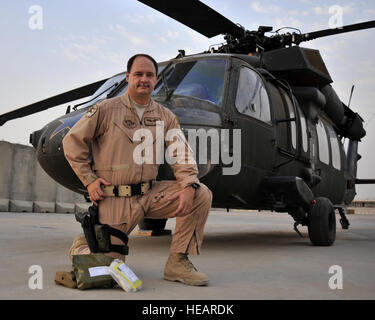 Lt. Col. (Dr.) Tim Cathey was a passenger aboard a UH-60 Black Hawk helicopter, like the one pictured, when the aircraft was diverted from its mission to rescue an Iraqi soldier injured by an improvised explosive device. The mission took the doctor over Baghdad and into the countryside where American Soldiers had prepared the Iraqi for transport. With nothing more than the basic medical supplies contained in the standard issue combat first aid kit, as displayed in front of him, Doctor Cathey managed to treat and stabilize his patient as the Black Hawk pilot skillfully flew at top speeds to get Stock Photo