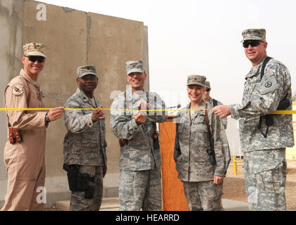 JOINT BASE BALAD, Iraq — From left to right, Brig. Gen. Brian Bishop, 332nd Air Expeditionary Wing commander; Lt. Col. George Petty, 332nd Expeditionary Civil Engineer Squadron commander; Col. Sal Nodjomian, 332nd Expeditionary Mission Support Group commander; Maj. Natalie Bonetti, 332nd Expeditionary Force Support Squadron commander; and Brig. Gen. Michael Lally, 3rd Sustainment Command (Expeditionary) commanding general, cut a ribbon to mark the opening of the Morale, Welfare, and Recreation Complex and West Fitness Annex in Housing Area 5/Housing Area 7 here June 20. The complex, which incl Stock Photo