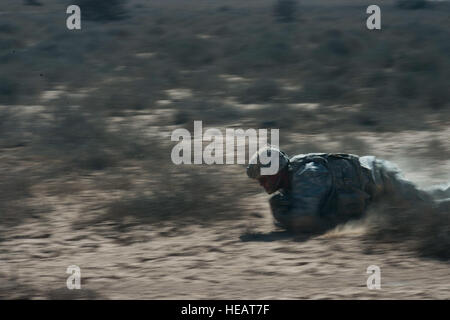 A Soldier from Alpha Company,1st Armored Battalion, 77th Armored Regiment 3rd Armored Brigade Combat Team, 1st Armored Division, East Africa Response Force (EARF) low crawls from the prone position during a live fire training exercise at the Arta training range in Djibouti, May 30, 2015. The EARF is a quick reaction force designed to defend U.S. assets within the Combined Joint Task Force Horn of Africa area of responsibility. ( Staff Sgt. Gregory Brook/ Released) Stock Photo