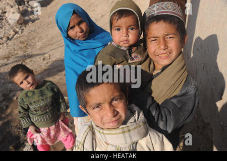 Afghan children watch Afghan and coalition Soldiers conduct a combined operation Jan. 10 in the Arghandab River Valley in Rajan Qala, Afghanistan. : Staff Sgt. Christine Jones) Stock Photo