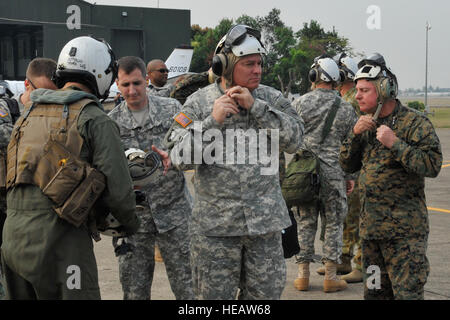 U.S. Army Lt. Gen. Francis Wiercinski, center, and U.S. Marine Lt. Gen. Terry Robling, right, adjust the straps on their protective headgear Feb. 21 prior to boarding a U.S. Marine Corps MV-22B Osprey at Wing 41 Royal Thai Air Force Base in Chiang Mai province, Kingdom of Thailand. The aircraft will transport the general officers to Ban Dan Lan Hoi, Sukothai province, to attend a combined arms live-fire exercise, which is the culminating event of exercise Cobra Gold 2013. As the largest multinational exercise in the Asia-Pacific region, CG 13 has demonstrated the commitment of partner nations  Stock Photo