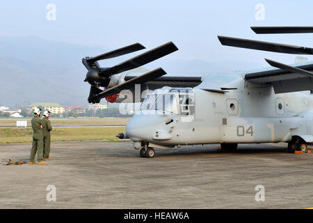 U.S. Marine Corps MV-22B Osprey crew chiefs perform pre-flight checks at Wing 41 Royal Thai Air Force Base, Chiang Mai province, Kingdom of Thailand, Feb. 21 during exercise Cobra Gold 2013. The crew chiefs, who are assigned to Marine Medium Tiltrotor Squadron 265, Marine Aircraft Group 36, 1st Marine Aircraft Wing, III Marine Expeditionary Force, participated in the exercise, which was designed to enhance interoperability with multinational forces and strengthen relationships in the Asia-Pacific region.  Master Sgt. Jason Vaught Stock Photo