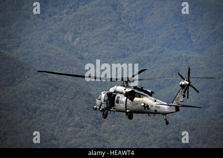 A 33rd Rescue Squadron HH-60 Pave Hawk flies through mountains near Osan Air Base, Republic of Korea, to kick off the first day of Pacific Thunder 2012 during a combat search and rescue training mission at Osan AB Oct. 12, 2012. Pacific Thunder 2012 is an annual two-week exercise where members of the 33rd and 31st Rescue Squadrons met up with the 25th Fighter Squadron and multiple other units at Osan AB, to test CSAR tactics to prepare for real-world emergency situations. Stock Photo