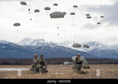 Paratroopers assigned to the 4th Infantry Brigade Combat Team (Airborne), 25th Infantry Division, U.S. Army Alaska, practice a forced-entry parachute assault on Malemute drop zone at Joint Base Elmendorf-Richardson, Alaska, March 18, 2015, as part of a larger tactical field exercise. The Soldiers are part of the Army’s only Pacific airborne brigade with the ability to rapidly deploy worldwide, and are trained to conduct military operations in austere conditions. Alejandro Pena) Stock Photo