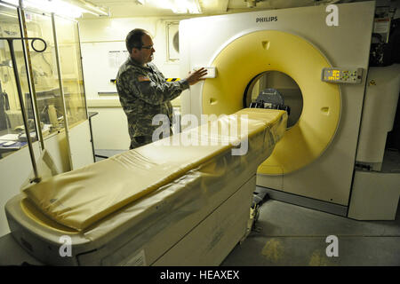 U.S. Army Maj. Corey William, a radiologist assigned to the 320th Medical Company (Hospital), Greensboro, N.C., shows off a Multi-Detector 16 Slice computed tomography scanner May 6, 2014.  Exercise Patriot Warrior at Fort McCoy, Wis., is the first time that a CT scanner has been used during a reserve field training event. United States military reserve components from all branches participate in combined exercises Patriot Warrior, Global Medic, Diamond Saber and CSTX in preparation for upcoming deployments in joint environments.  Master Sgt. Francisco V. Govea II/ Released) Stock Photo