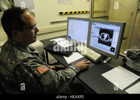 U.S. Army Maj. Corey William, a radiologist assigned to the 320th Medical Company (Hospital), Greensboro, N.C., shows off a Multi-Detector 16 Slice computed tomography scanner May 6, 2014.  Exercise Patriot Warrior at Fort McCoy, Wis., is the first time that a CT scanner has been used during a reserve field training event. U.S. military reserve components from all branches participate in combined exercises Patriot Warrior, Global Medic, Diamond Saber and CSTX in preparation for upcoming deployments in joint environments.  Master Sgt. Francisco V. Govea II/ Released) Stock Photo