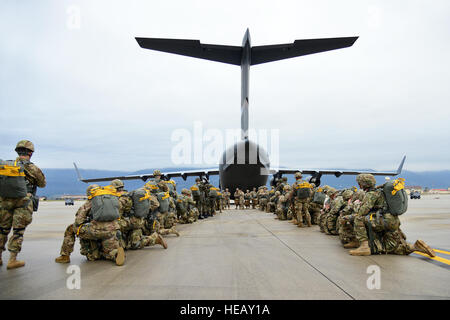 Hundreds of paratroopers from the Hungarian army’s 2nd Special Forces Regiment, Polish 6th Airborne Brigade, Romania’s 6th Special Operations Brigade, and the U.S. Army’s 173rd Airborne Brigade, prepare to board a  C17 Globemaster III Aircraft from Papa Air Base, Hungary at Aviano Air Base, Italy, Oct. 17, 2016, as a part of Peacemaster Unity training. Peacemaster Unity is Joint multinational readiness exercise including participation from seven nations conducting missions across three countries, delivering over 2000 troops and 20 heavy drops. The 173rd Airborne Brigade is the U.S. Army Contin Stock Photo