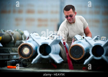 Airman 1st Class James Haddock, 4th Aircraft Maintenance Squadron aircraft armament systems apprentice, Seymour Johnson Air Force Base, N.C., checks the wiring pins of a GBU-12 inert bomb during Green Flag-West 13-5, June 24, 2013, at Nellis Air Force Base, Nev. Green Flag-West provides a realistic close-air support training environment for Airmen and soldiers preparing to deploy in support of combat operations. Senior Airman Brett Clashman) Stock Photo