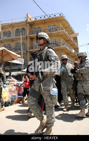 U.S. Army Pfc. Joshua Gibson, of New Orleans, La., from the 2nd Battalion, 20th Field Artillery Regiment, 41st Fires Brigade, leads security while Iraqi security forces and U.S. Soldiers, police the marketplace in Al Hayy, Iraq, on April 20. Stock Photo