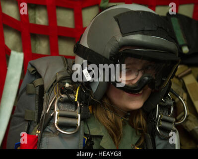 KEFLAVIK, Iceland -- Kolbrun Erlendsdottir, 11, wears pararescue equipment in the back of a C-130J Super Hercules during the pilot-for-a-day program at Keflavik International Air Port May 23, 2014. Airmen deployed with the 48th Air Expeditionary Group took time out of their day to brighten the lives of two children, Kolbrun and Mikolaj Chojecki, who have been struggling with serious long-term illnesses. Tech. Sgt. Benjamin Wilson)(Released) Stock Photo