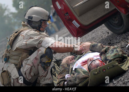 U.S. Air force photo of pararescuemen SRA Ryan Belew 0f the 123rd Special tactical Squadron preparing a patient for transporting  by litter during the Mass casualty exercise at the 2008 Para Rescue Rodeo hosted by the 123rd Special Tactics Squadron Kentucky Air National Guard. The rodeo consisted of Air Force, Air Force Reserve, Air National Guard and Canadian participants. During the weeklong event consisting of eight different teams they competed in five different areas. Mass casualty, Urban Tactical Personal Recovery, Confine Space, Rescue Jump Master, and the Canopy Accuracy event. The Mai Stock Photo