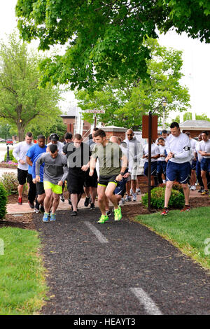 Participants take off at the beginning of a Memorial 5k Run for National Police Week at Scott Air Force Base, Ill., May 14, 2014. The run was held to show appreciation for law enforcement members and the sacrifices they make daily. A golf tournament was also held at the start of the week for local police officers and Security Forces following a breakfast.  Airman 1st Class Kiana Brothers Stock Photo