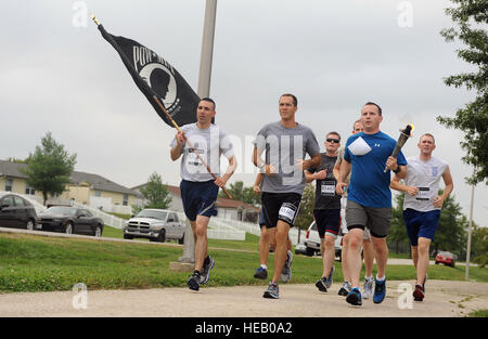 U.S. Air Force Chief Master Sgt. Shawn L. Drinkard, command chief of the 509th Bomb Wing, and other members of Team Whiteman participate in the annual Prisoners of War/Missing in Action run at Whiteman Air Force Base, Mo., Sept.18, 2014. Since 2013, six Airmen previously unaccounted for from the Vietnam War have been brought home.  Airman 1st Class Jovan Stock Photo
