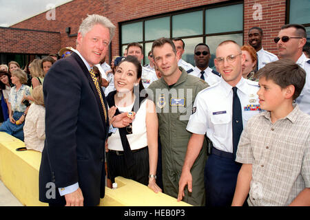 President William Jefferson Clinton holds a coin presented to him by the 84th Airlift Flight Commander, Major Sandy J. Krigel (In flight suit) and his wife Lili (Next to the Pres.). This event to place upon the President's departure from Peterson Air Force Base, Colorado, on June 2nd, 1999. Stock Photo