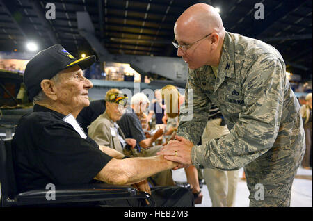 Col. Jeffrey King, Robins’ installation and 78th Air Base Wing commander, greets John Barrett, Army veteran, during a reception at the Museum of Aviation in Warner Robins, Ga., Aug. 21. Barrett – a private first class during the war -- received a Purple Heart and Silver Star after being wounded in action and taken as a prisoner of war during World War II. The reception honored veterans who served aboard B-17s and celebrated the arrival of a B-17 Flying Fortress which will be displayed at the museum. The engines, wings and tail section of the aircraft -- which arrived a day earlier -- were on d Stock Photo