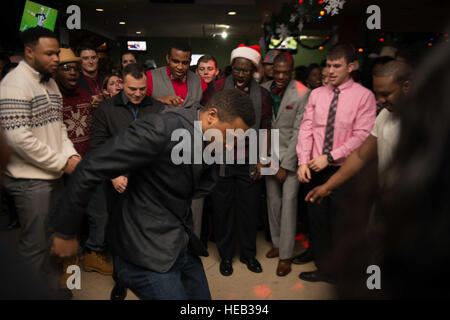 151210-N-DA737-073 SILVERDALE, Wash. (Dec. 10, 2015) - Aviation Structural Mechanic Airman Dominik Stanberry, from Los Angeles, dances during USS John C. Stennis' (CVN 74) command holiday party. Stennis' crew is currently in port training for future deployments.  Mass Communication Specialist 3rd Class Jonathan Jiang / Released) Stock Photo