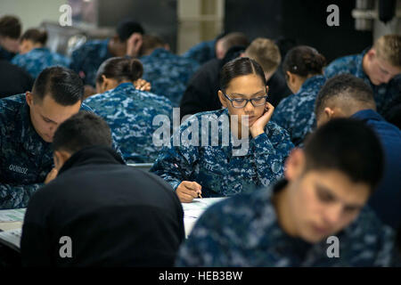 150917-N-DA737-030 BREMERTON, Wash. (Sept. 17, 2015) - Aviation Electronics Technician Airman Lilian Lete, from Santa Ana, Calif., takes the Navy-wide advancement exam on USS John C. Stennis' (CVN 74) middle mess decks. The Navy offers eligible candidates two opportunities per year, once in the spring and once in the fall, to test for the next higher pay grade. The Stennis crew is currently in port training for future deployments.  Mass Communication Specialist 3rd Class Jonathan Jiang / Released) Stock Photo