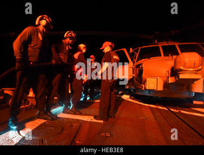 160725-N-KR702-165  PACIFIC OCEAN (June 25, 2016) - Sailors assigned to the Arleigh Burke-class guided-missile destroyer USS Shoup (DDG 86) conduct a crash and salvage damage control drill at night on the flight deck, during Rim of the Pacific 2016. Twenty-six nations, more than 40 ships and submarines, more than 200 aircraft and 25,000 personnel are participating in RIMPAC from June 30 to Aug. 4, in and around the Hawaiian Islands and Southern California.  The world's largest international maritime exercise, RIMPAC provides a unique training opportunity that helps participants foster and sust Stock Photo