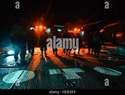 160725-N-KR702-103  PACIFIC OCEAN (June 25, 2016) - Sailors assigned to the Arleigh Burke-class guided-missile destroyer USS Shoup (DDG 86) walk the flight deck at night looking for foreign object debris in preparation for flight operations, during Rim of the Pacific 2016. Twenty-six nations, more than 40 ships and submarines, more than 200 aircraft and 25,000 personnel are participating in RIMPAC from June 30 to Aug. 4, in and around the Hawaiian Islands and Southern California.  The world's largest international maritime exercise, RIMPAC provides a unique training opportunity that helps part Stock Photo