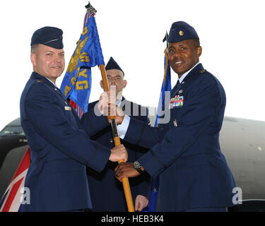 From left, Col. Joseph Rushlau, 100th Maintenance Group commander, hands the 100th Aircraft Maintenance Squadron guidon to Maj. Rofelio Grinston, incoming 100th AMXS commander, during the 100th AMXS change of command ceremony June 18, 2013, on RAF Mildenhall, England. Grinston previously served as the 6th Maintenance Operations Squadron commander, at MacDill Air Force Base, Fla., providing financial, administrative, facility, quality assurance, contractual analysis, scheduling, engine management, and computer network support for 16 KC-135 Stratotankers and three C-37A aircraft.  Airman 1st Cla Stock Photo