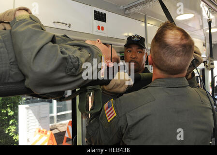 Joseph Randolph, Department of Veterans Affairs surgical nurse, listens to instruction by a 375th Aeromedical Evacuation Squadron member on how to secure a patient litter during training  June 7, 2016 at the MidAmerica St. Louis Airport in Mascoutah, Illinois.  The training was conducted in order to familiarize the DMV on military equipment, so coordination efforts during natural and man-made disasters will be more effective.  Staff Sgt. Maria Bowman) Stock Photo