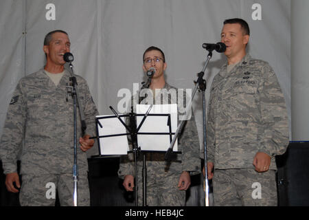 Staff Sgt. John Raab, 1st Lt. Jerry Underwood and Capt. Erik Stohl, members of the 506th Air Expeditionary Group, performed for more than 60 Airmen and Soldiers at the Clamtina at Kirkuk Regional Air Base, Iraq, Aug. 30, 2009. The trio, known as '3 Krab Night,' formed after hearing each other sing the national anthem at different ceremonies here. The acappella band sang a variety of music from classic to modern. Stohl, a Tacoma, Wash., native, is deployed here from the 194th Regional Support Wing, Camp Murry, Wash. Underwood, a Tyler, Texas, native, is deployed here from the 451st Intelligence Stock Photo