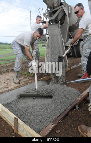 GUANTANAMO BAY, Cuba – Members of the 474th Expeditionary Civil Engineer Squadron build a walkway in Camp Buckley, Oct. 21, 2010. The 474th is attached to the 161st Air Refueling Wing, Phoenix, Ariz. working here in support of Joint Task Force Guantanamo.  JTF Guantanamo provides safe, humane, legal and transparent care and custody of detainees, including those convicted by military commission and those ordered released by a court. The JTF conducts intelligence collection, analysis and dissemination for the protection of detainees and personnel working in JTF Guantanamo facilities and in suppo Stock Photo