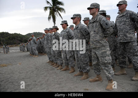 U.S. Soldiers with the 525th Military Police Battalion stand at parade rest during a change of command and change of responsibility ceremony, July 13, 2010. Army Lt. Col. Alexander Conyers and Army Command Sgt. Maj. Steven M. Raines relinquished their command positions after two years with the unit at Joint Task Force Guantanamo. Stock Photo