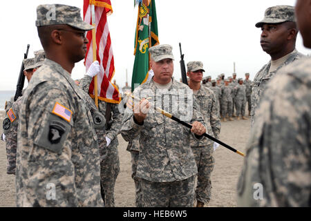 GUANTANAMO BAY, Cuba – Army Command Sgt. Maj. Steven M. Raines holds the Army Non-Commissioned Officer’s sword before passing it to Army Lt. Col. Alexander Conyers (right) during a change of responsibility ceremony, July 13, 2010. Conyers and Raines relinquished their command positions after two years with the unit at Joint Task Force Guantanamo. JTF Guantanamo provides safe, humane, legal and transparent care and custody of detainees, including those convicted by military commission and those ordered released by a court. The JTF conducts intelligence collection, analysis and dissemination for Stock Photo