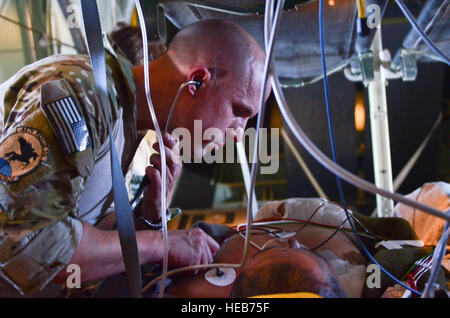 Capt. Russell Gray, 48th Rescue Squadron  Flight Surgeon, checks the breathing of a sailor rescued 1,100 nautical miles off the Pacific Coast of Mexico May 5, 2014. The sailor was hoisted from a ship 540 nautical miles off the Pacific coast of Mexico. A 79th RQS HC-130J Combat King II then transported the personnel and Capt. Gray, to Naval Air Station North Island, Calif.  Staff Sgt. Adam Grant Stock Photo