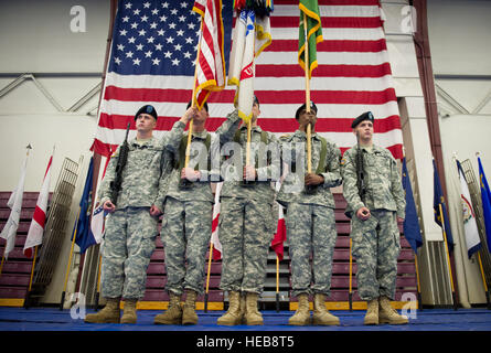 Soldiers stand at the position of attention with the colors during the inactivation ceremony for the 793rd Military Police Battalion, 2nd Engineer Brigade, U.S. Army Alaska, at the Buckner Physical Fitness Center on Joint Base Elmendorf-Richardson, Alaska, Thursday, Aug. 28, 2014. The 793rd Military Police Battalion was activated on Dec. 26, 1942, at Camp Maxey, Texas. The 793rd Military Police Battalion has been on nearly 72 years of consecutive service, and deployed to the European Theater of Operations in World War II, performed numerous Cold War era missions, and took part in Operations De Stock Photo