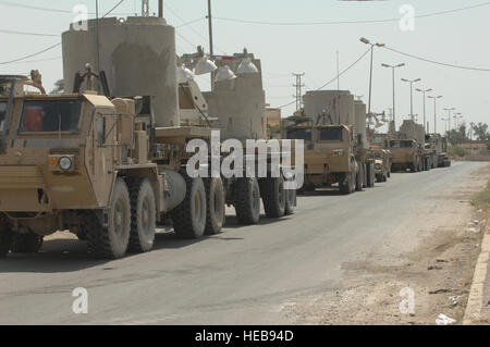 U.S. Army Soldiers with the Forward Support Company, 2nd Battalion, 82nd Airborne Division, deliver guard towers that the Iraqi national police will use in the city of Samarra, Iraq, July 31. Stock Photo